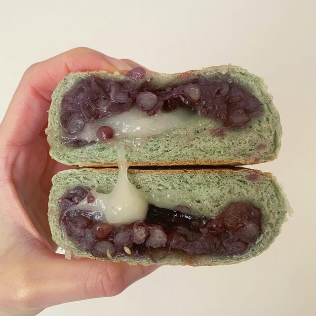 Representative matcha bagel cut in half, stuffed with red bean and stretchy mochi